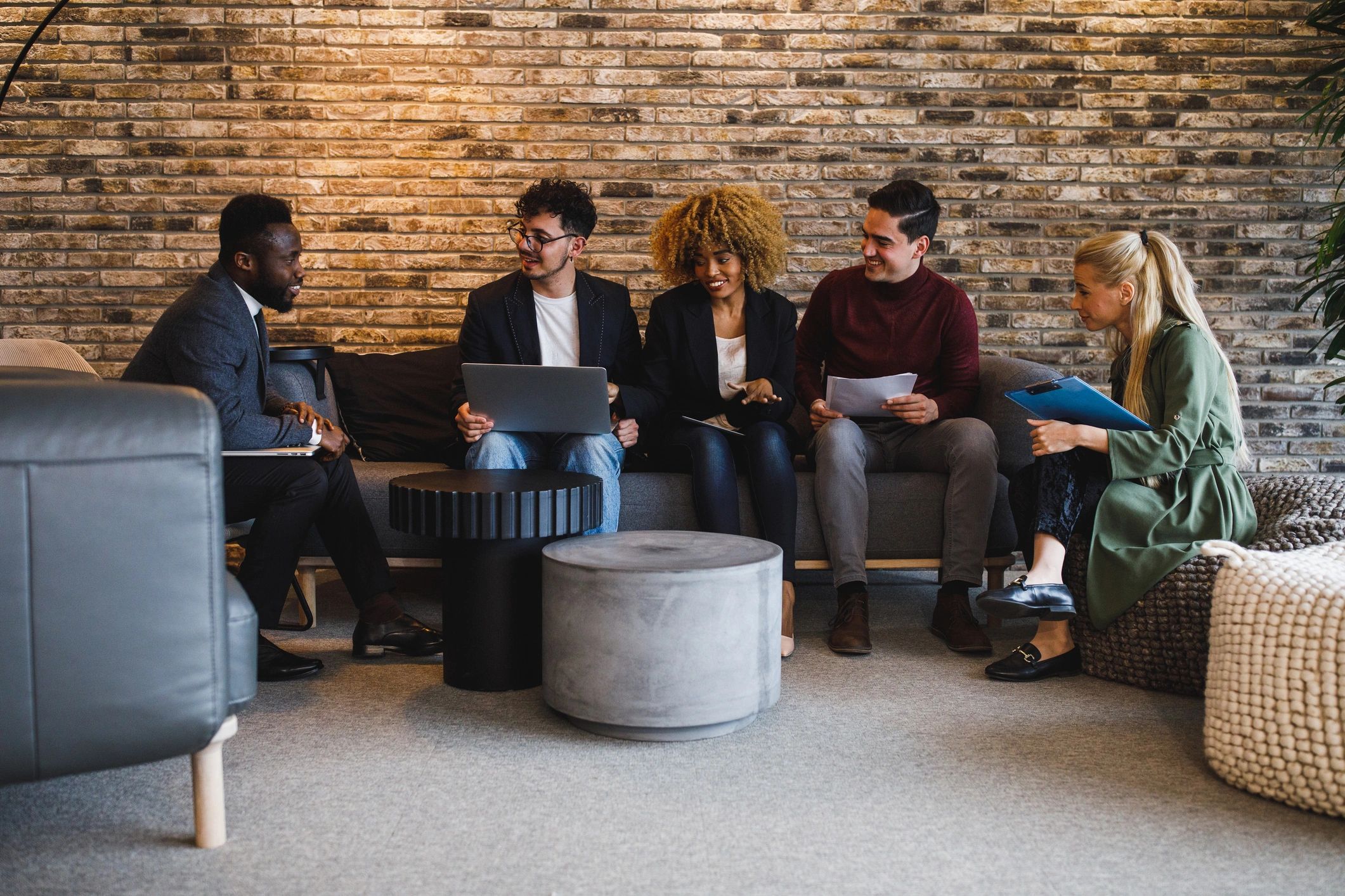 Diverse local business team with men and women meeting to discuss marketing collaboration